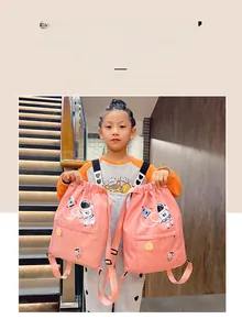 Detail of pink children's drawstring bag with astronaut embroidery and side zipper pocket