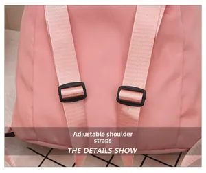 Close-up of adjustable nylon shoulder straps with black plastic buckles on a pink backpack