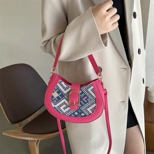 Pink half-moon shoulder bag with geometric tapestry and gold buckle detail