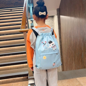 Rear view of a light blue nylon drawstring backpack with cartoon astronaut embroidery