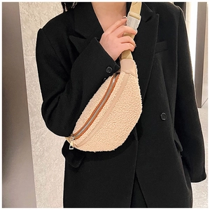 Detailed view of beige plush fleece waist bag with adjustable strap and plastic buckle