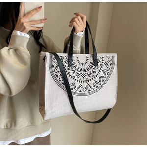 Detail of minimalist tote bag with black geometric print and premium leather straps