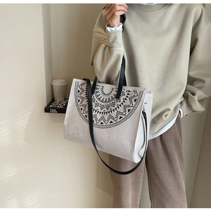 Close-up of bohemian geometric print on canvas tote bag with black leather handle