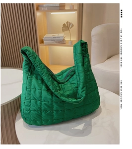 Detailed macro view of vibrant green quilted cloud tote bag with large square stitching