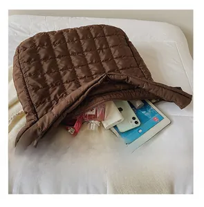 Interior view of large brown quilted tote bag showing space for iPad and essentials