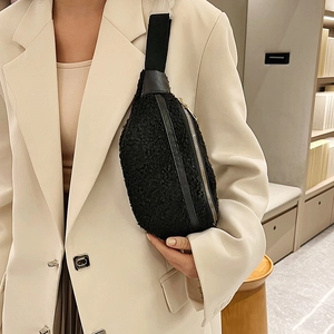 Fashionable black sherpa crossbody chest bag with wide strap for women on white suit