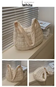 Close-up of cream puffer tote bag with quilted square patterns and padded shoulder straps
