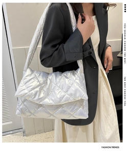 Silver quilted metallic puffy handbag detail showing sleek rhombic embroidery on soft texture