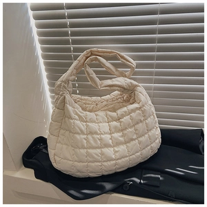 Macro shot of off-white quilted puffer fabric texture and high-quality stitching detail