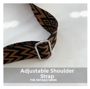 Detail of adjustable shoulder strap with brown and black geometric pattern and silver buckle
