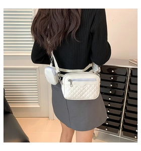 Detail of white quilted crossbody bag with adjustable jacquard strap and small coin pouch