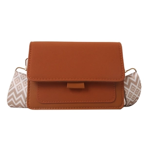 Brown leather crossbody bag with patterned wide strap and gold metal hardware