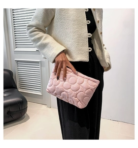 Detailed view of pink quilted handbag showing soft nylon texture and bubbly padded design