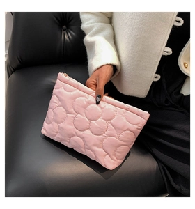 Macro detail of pink floral quilted fabric bag with high-quality metal zipper closure
