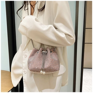 Vue détaillée du sac seau rose en strass avec bandoulière et cordon en perles