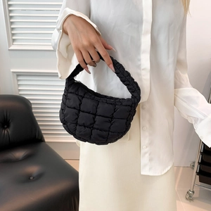 Chic black quilted cloud bag with ruched handles, modern nylon tote worn by model