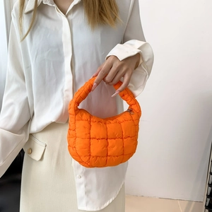 Bright orange quilted cloud handbag for women featuring puffer design and mini top handle