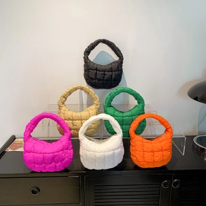 Quilted mini cloud bags in six colors displayed on a display stand for women