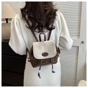 Detailed shot of retro brown mini backpack with silver gold flap and fashion debossing