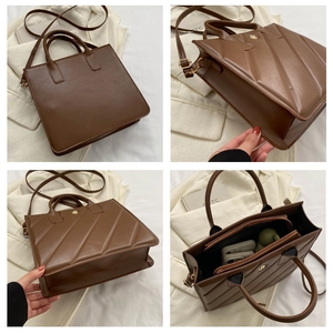 Detail of dark brown tote bag with diagonal stitching and adjustable shoulder strap