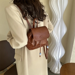Vintage brown leather mini backpack with FASHION logo flap and drawstring for women