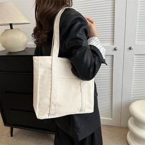Sac fourre-tout minimaliste en toile avec bandoulières et poche avant sur mannequin