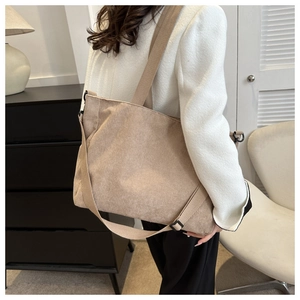 Detail of the corduroy tote bag featuring vertical ribbed texture and adjustable strap