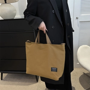 Minimalist canvas tote bag in mustard yellow with large capacity and shoulder strap