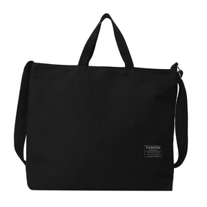 Minimalist black canvas tote bag with dual handles and long strap on white background
