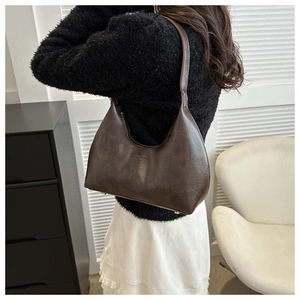 Détail du sac sous l'aisselle en cuir rétro marron foncé avec texte mode embossé