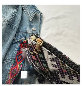 Detail of colorful ethnic jacquard knit crossbody bag with premium gold metal zipper