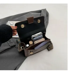 Top view of retro brown crossbody bag showing spacious interior and jacquard strap