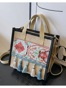 Ethnic embroidery tote bag with colorful floral patterns and tassels on linen fabric