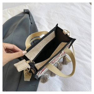 Detailed interior of ethnic tote bag with embroidery, fringe, and detachable strap