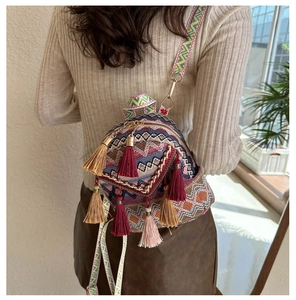 Detailed close-up of bohemian woven bag featuring colorful patterns and multi-colored tassels
