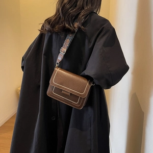 Brown vintage leather crossbody bag with ethnic patterned wide strap and white stitching