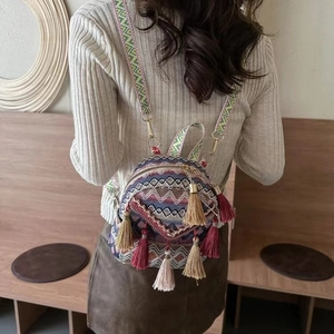 Ethnic mini backpack featuring colorful geometric patterns and long decorative tassels