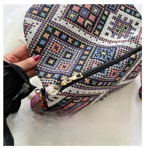 Détail de la fermeture éclair en métal et du motif ethnique tissé du sac à bandoulière