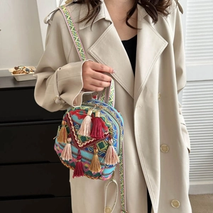 Ethnic bohemian canvas crossbody bag with vibrant geometric patterns and colorful long tassels