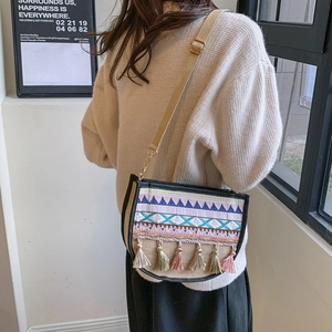 Ethnic crossbody bag with geometric embroidery and colorful tassels for a boho look