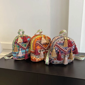 Three Bohemian ethnic mini backpacks with colorful embroidery and tassel fringe decor