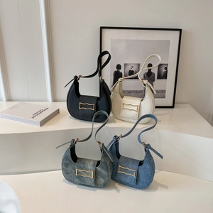 Fashionable half-moon hobo bags in leather and denim with elegant gold buckle detail