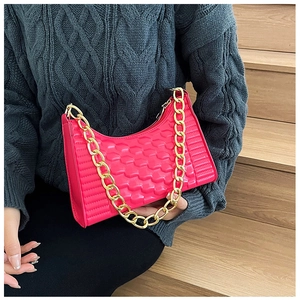 Close-up of rose red crescent bag with wavy quilted texture and gold chain strap