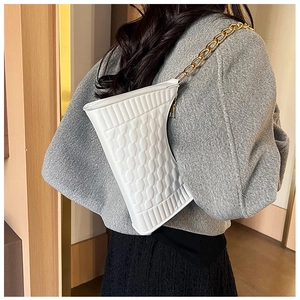 Detail of white asymmetrical crescent bag with woven texture and gold chain strap