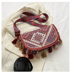 Détail du sac tissé bohème aux motifs géométriques et longues franges multicouches