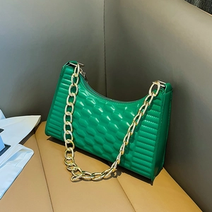 Modern bright green crescent shoulder bag with honeycomb texture and gold chain strap