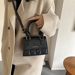 Classic black quilted leather handbag with gold buckle and adjustable strap