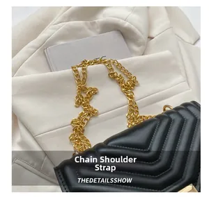 Close-up of black V-quilted leather handbag featuring a chunky gold chain strap