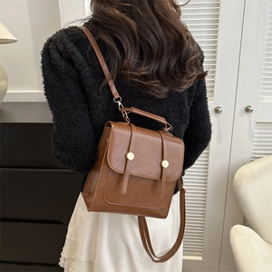 Retro brown PU leather backpack with vintage buckle straps and gold metallic accents