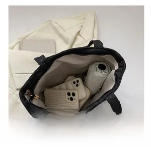 Macro view of the large interior space of this quilted tote bag showing high capacity